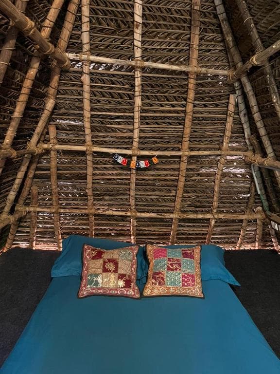 Inside the Triple Hut — bed and window view